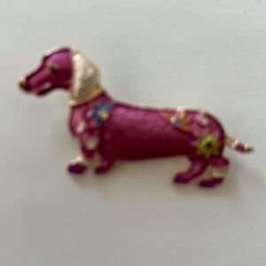 A pink dachshund with gold ears now that's a fun pin. Floral colors adorn her